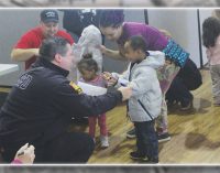 Local firefighters, Family Services give winter coats to preschoolers