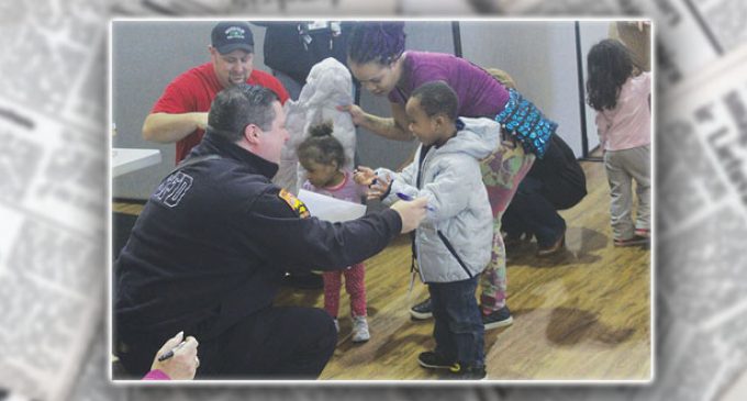 Local firefighters, Family Services give winter coats to preschoolers