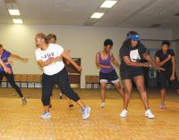 Fitness class grooves to gospel music while working out