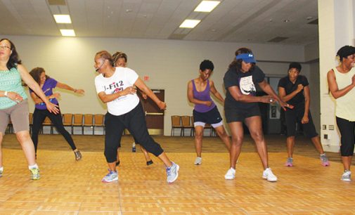 Fitness class grooves to gospel music while working out