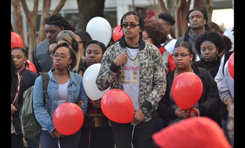 Vigil honors student as police look for suspect