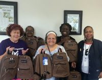 Quality Independent Living delivers book bags for the homeless