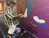 Local artist Leo Rucker and art students create murals to  brighten school hallways