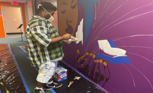 Local artist Leo Rucker and art students create murals to  brighten school hallways